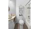Bathroom featuring a toilet, shower-tub combination, and decorative shelves for storage at 357 Heritage Estates Ln, Deland, FL 32720