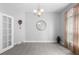 Inviting dining room showcasing a chandelier, round mirror, gray flooring, and neutral wall colors at 357 Heritage Estates Ln, Deland, FL 32720