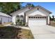 Charming single-Gathering home featuring arched windows, a two-car garage and well-maintained landscaping at 357 Heritage Estates Ln, Deland, FL 32720