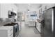 Well-lit kitchen featuring white cabinets, stainless steel appliances, and modern backsplash at 357 Heritage Estates Ln, Deland, FL 32720