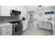 Bright kitchen showcasing white cabinets, stainless steel appliances and tile flooring at 357 Heritage Estates Ln, Deland, FL 32720