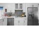Close up on kitchen area, featuring stainless steel appliances, white cabinetry and modern fixtures at 357 Heritage Estates Ln, Deland, FL 32720
