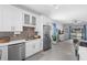 Well-equipped kitchen with modern appliances, white cabinets, and stylish backsplash for a contemporary feel at 357 Heritage Estates Ln, Deland, FL 32720