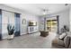 Open-concept living room with tile floors, modern decor, and sliding glass doors to the backyard at 357 Heritage Estates Ln, Deland, FL 32720