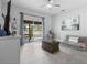 Bright living room with neutral tones, tile floors, and access to outdoor patio at 357 Heritage Estates Ln, Deland, FL 32720