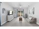 Spacious living room with tile floors, modern furniture, and sliding glass doors to the backyard at 357 Heritage Estates Ln, Deland, FL 32720