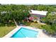 Aerial view showing a building adjacent to the pool area with landscaped grounds at 3800 Saxon Dr # 150, New Smyrna Beach, FL 32169