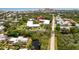 Aerial view showcases condo buildings with community pool, surrounding foliage, and proximity to water at 3800 Saxon Dr # 150, New Smyrna Beach, FL 32169