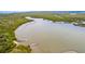 Picturesque aerial view of the river, the dock, and lush mangroves surrounding the area at 3800 Saxon Dr # 150, New Smyrna Beach, FL 32169