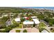 Aerial view of condo complex featuring a sparkling community pool and lush landscaping at 3800 Saxon Dr # 150, New Smyrna Beach, FL 32169