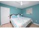 Comfortable bedroom features a Queen sized bed with blue accents and neutral walls at 3800 Saxon Dr # 150, New Smyrna Beach, FL 32169
