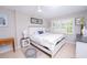 Bright bedroom with white furniture, neutral walls, shuttered windows and decorative artwork at 3800 Saxon Dr # 150, New Smyrna Beach, FL 32169