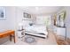 Inviting bedroom with white furniture, shuttered windows and decorative artwork at 3800 Saxon Dr # 150, New Smyrna Beach, FL 32169