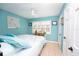 Tranquil bedroom with blue walls, white shuttered windows, and comfortable bed at 3800 Saxon Dr # 150, New Smyrna Beach, FL 32169