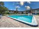 Inviting community pool with lounge chairs and umbrellas offers a resort-like experience at 3800 Saxon Dr # 150, New Smyrna Beach, FL 32169