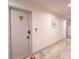 Hallway with wood-look tile flooring and whale door decoration at 3800 Saxon Dr # 150, New Smyrna Beach, FL 32169