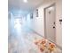Hallway with wood-look tile flooring, neutral paint, and decorative accents at 3800 Saxon Dr # 150, New Smyrna Beach, FL 32169