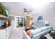 Bright and airy living room featuring a ceiling fan, sliding glass doors, and comfortable seating at 3800 Saxon Dr # 150, New Smyrna Beach, FL 32169