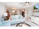 Bright and airy living room featuring a ceiling fan and comfortable seating at 3800 Saxon Dr # 150, New Smyrna Beach, FL 32169