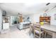 Living area features patio doors, comfortable seating and dining area with seating for four at 3800 Saxon Dr # 150, New Smyrna Beach, FL 32169