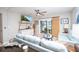 Bright and airy living room featuring a ceiling fan, sliding glass doors, and comfortable seating at 3800 Saxon Dr # 150, New Smyrna Beach, FL 32169
