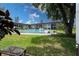 Enjoy community living with a refreshing pool surrounded by green space, seating, and palm trees at 3800 Saxon Dr # 150, New Smyrna Beach, FL 32169