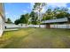 Well-maintained, fenced backyard features a shed, covered patio, and ample green space at 430 Spring Dr, Ocala, FL 34472