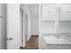 The bathroom has a modern vanity and sink, with a view of the hallway, ready for you to use at 430 Spring Dr, Ocala, FL 34472