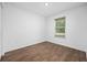 A spacious room with wood floors, natural light, and a window looking outside, make this a wonderful bedroom at 430 Spring Dr, Ocala, FL 34472