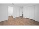 This bedroom has wood floors, and a closet, with an attached bathroom, ready to be moved into and enjoyed at 430 Spring Dr, Ocala, FL 34472