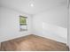 This is a spacious bedroom that has a view to the yard outside, natural light, and wood floors at 430 Spring Dr, Ocala, FL 34472