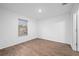 A bright bedroom featuring a large window and wood-look flooring at 430 Spring Dr, Ocala, FL 34472
