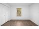 A bright bedroom featuring a large window and wood-look flooring at 430 Spring Dr, Ocala, FL 34472