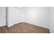 This bedroom has wood floors, natural light, a closet and access to the hallway at 430 Spring Dr, Ocala, FL 34472