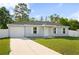 Beautiful single story home with a new roof, long driveway, and lush landscaping at 430 Spring Dr, Ocala, FL 34472