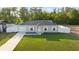 Charming one-story home with a well-manicured lawn, white picket fence, and a single-car garage for convenient parking at 430 Spring Dr, Ocala, FL 34472