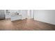 Open-concept living area with wood flooring seamlessly connecting to the kitchen with stainless steel appliances and granite countertops at 430 Spring Dr, Ocala, FL 34472