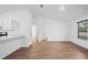 Open-concept living room with white walls and wood-look flooring at 430 Spring Dr, Ocala, FL 34472