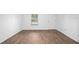 Well-lit room with durable flooring, a large window, and a door providing easy access to other areas of the home at 430 Spring Dr, Ocala, FL 34472