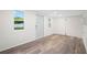 Bright and spacious room featuring modern flooring, a large window, and a door leading to the exterior at 430 Spring Dr, Ocala, FL 34472