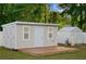 Close up of a backyard storage shed featuring a deck and a water softener system hook up at 430 Spring Dr, Ocala, FL 34472