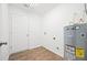 A utility room with wood floors and a hot water tank is ready for laundry needs at 430 Spring Dr, Ocala, FL 34472