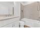 Clean bathroom featuring a white vanity with granite counters, tub, and tiled shower walls at 484 Landshark Blvd, Daytona Beach, FL 32124