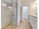 Luxurious bathroom with a glass-enclosed shower, and vanity with modern fixtures and ample lighting at 484 Landshark Blvd, Daytona Beach, FL 32124
