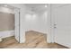 Bright, airy bedroom with ensuite bathroom featuring wood-look flooring and a ceiling fan at 484 Landshark Blvd, Daytona Beach, FL 32124