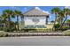 Welcome to a vibrant community, showcased by a stunning entrance with lush landscaping and tropical palm trees at 484 Landshark Blvd, Daytona Beach, FL 32124