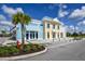 Inviting street view highlighting a charming yellow building with a light blue awning and lush landscaping at 484 Landshark Blvd, Daytona Beach, FL 32124