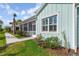 Charming coastal home with light blue siding, manicured lawn, and screened porch at 484 Landshark Blvd, Daytona Beach, FL 32124