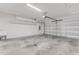Spacious garage featuring a utility sink, high ceilings, and an automatic garage door at 484 Landshark Blvd, Daytona Beach, FL 32124