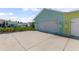 Attached garage with large driveway and a well manicured garden in a residential neighborhood at 484 Landshark Blvd, Daytona Beach, FL 32124